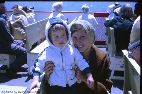 Mother and son watch a growing nuclear mushroom during a nuclear test