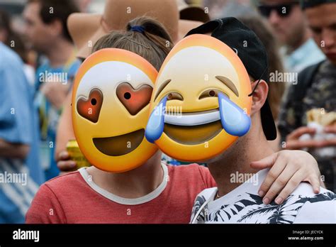 People wear emoji masks in the crowd in front of the Pyramid stage ...