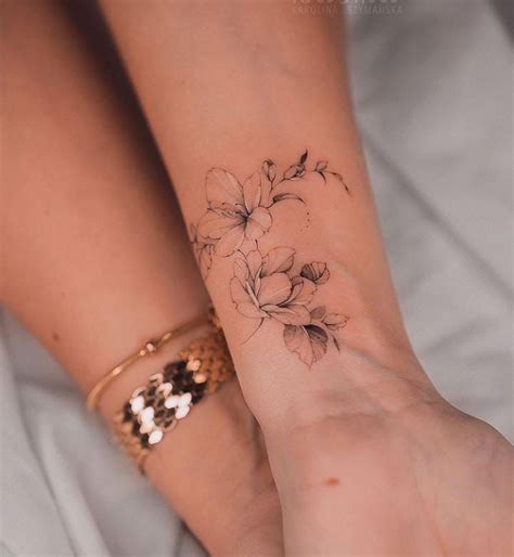 Floral wrist tattoo Flower wrist tattoo Wrist tattoo designs Feminine wrist tattoo Small wrist ...