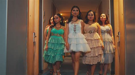 a group of sexy Asian women wear dresses and walk together in a hotel