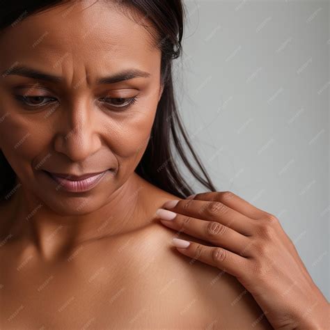 Unrecognizable woman hand checking lumps on her breast for signs of