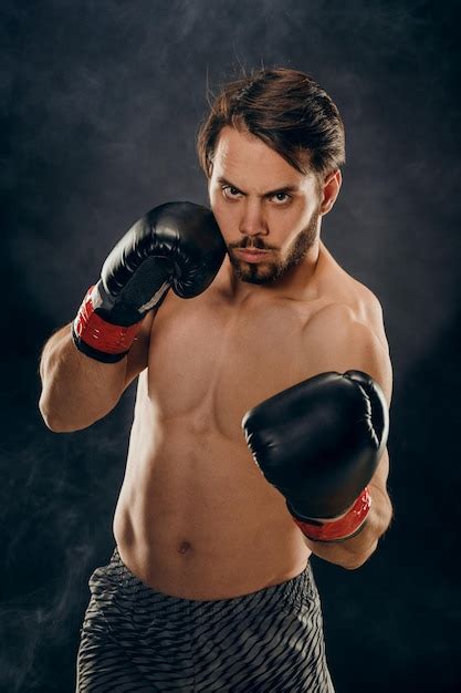 premium photo shirtless boxer  gloves  dark background  smoke