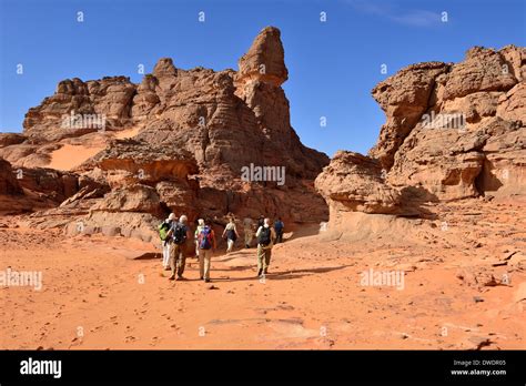 Algeria, Sahara, Tassili N'Ajjer National Park, group of people hiking ...