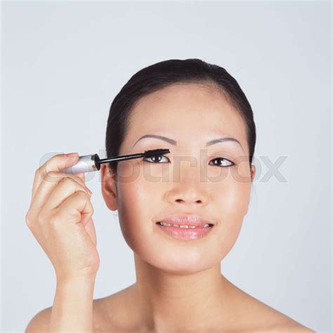 Young woman applying mascara | Stock image | Colourbox