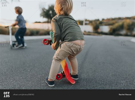 Toddler boy with pants falling down stock photo - OFFSET