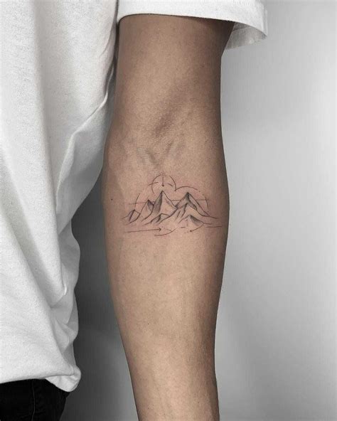 Beautiful minimalist mountains tattoo inked on the left forearm by Conz ...