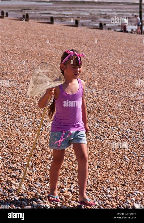 Girl walking along beach hi-res stock photography and images - Alamy