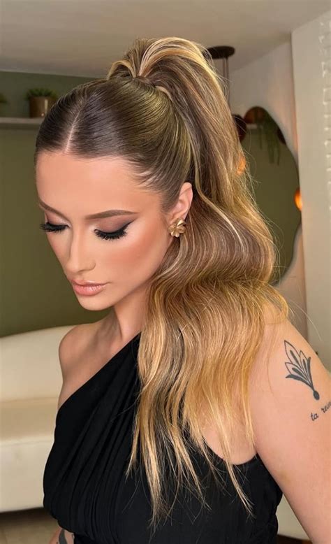glamorous high ponytail hairstyle  soft statement waves