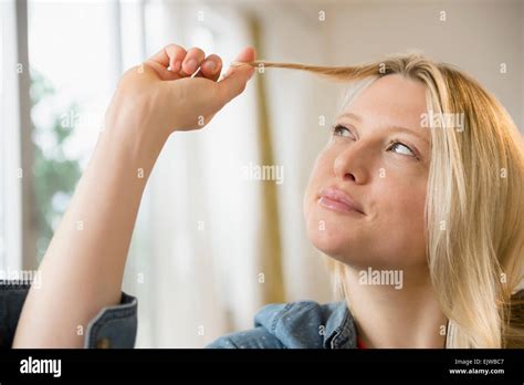 woman twisting  hair stock photo alamy