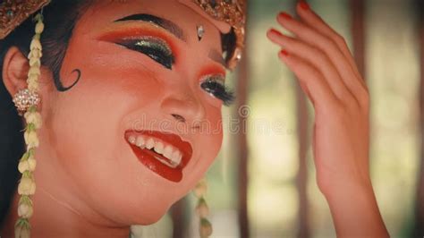 close    joyful javanese dancer   golden headdress stock