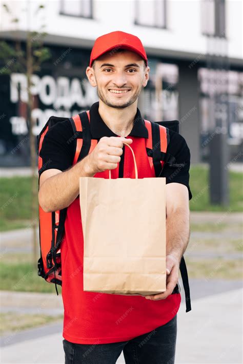 Premium Photo | Food delivery man order from a restaurant handsome
