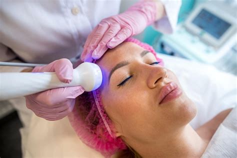 Premium Photo | Beautiful woman receives ultrasonic skin cleaning and ...