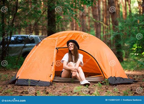 young woman resting  hat  camping tent  wilderness stock image