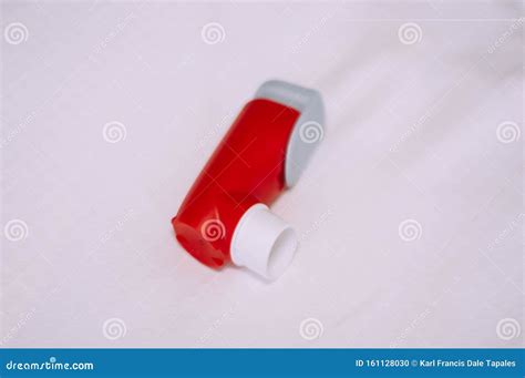 A Still Life of Red and White Asthma Inhaler Devise on a White ...