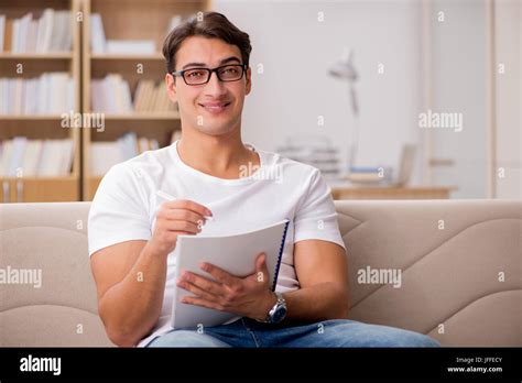 Man working sitting in couch sofa Stock Photo - Alamy