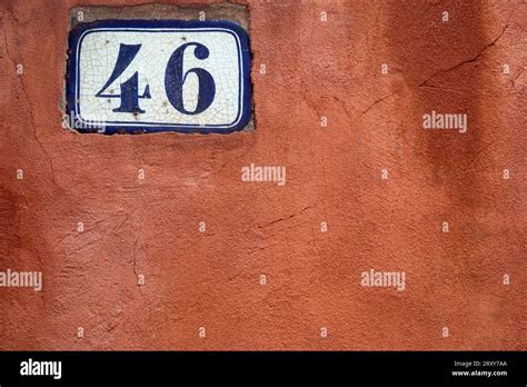 number   dark blue   white panel   red painted wall