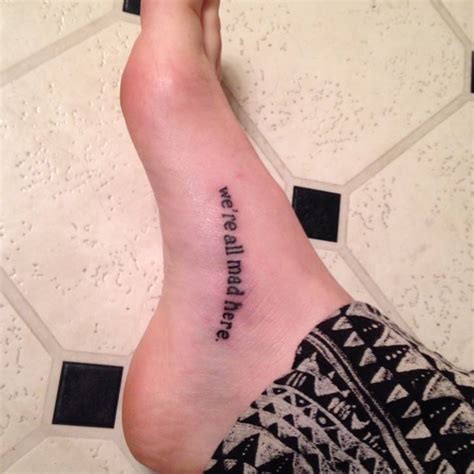 "We're all mad here" tattoo on the left foot, from