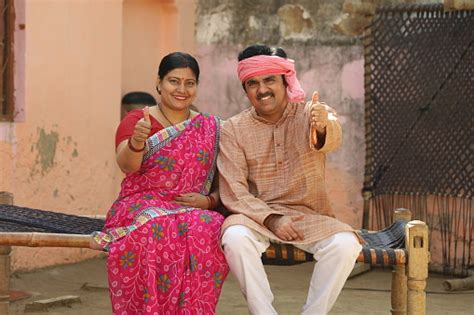 happy indian village family  husband  wife showing thumbs