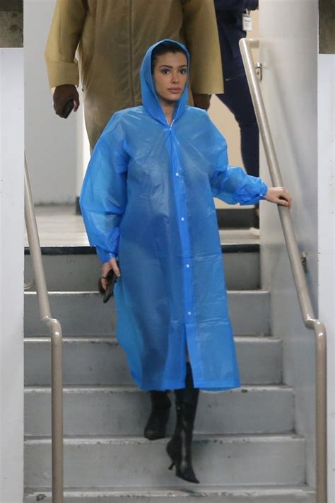 Bianca Censori and Kanye West sport matching raincoats — and nothing else