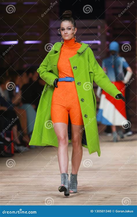 Twins fashion show editorial image. Image of coat, orange - 130501340