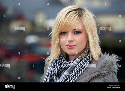 blonde 18 year old girl wearing jacket and heavy scarf eye contact and