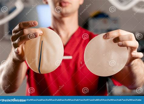 The Surgeon Shows Different Types of Silicone Implants. Breast Augmentation Surgery. Stock Photo ...