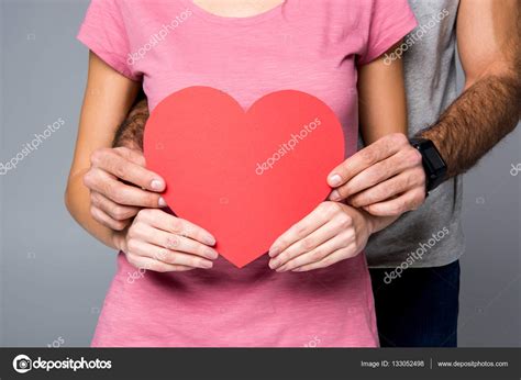 Young couple with red heart Stock Photo by ©SergKovbasyuk 133052498