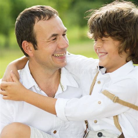 middle eastern man   son sitting   park stock image image