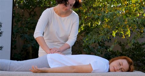 Woman do traditional chinese massage outdoors in summer garden 7665940