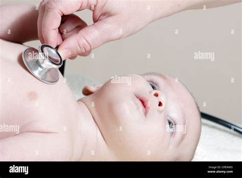 Stethoscope listening to a baby's heart beat Stock Photo - Alamy