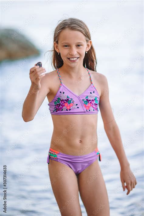 Cute little girl at beach during summer vacation Stock Photo | Adobe Stock