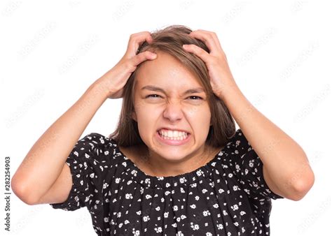 Angry teen girl, isolated on white background. Human emotions, facial expression concept. Upset ...