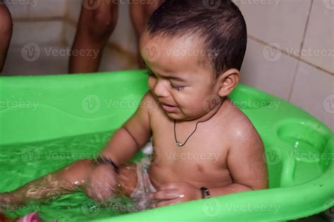 Cute Indian Boy having bath during the summer vacation season, Cute