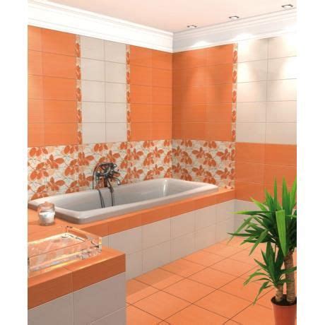 an orange and white tiled bathroom with a plant in the corner next to ...