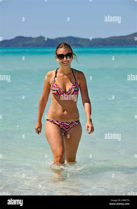 Young woman in the sea, Whitehaven Beach, Whitsunday Island, Whitsunday Islands National Park ...