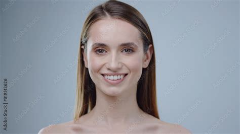 Charming face young naked woman look at camera smiling grey background