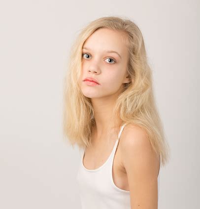 Beautiful Serious Blond Teenage Girl In White Top Stock Photo