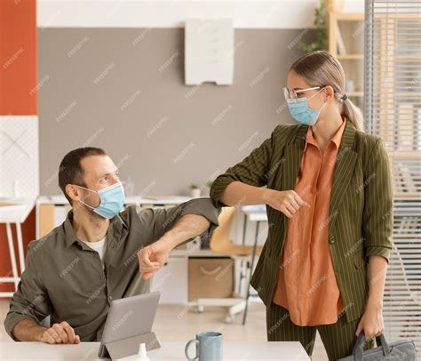 Premium Photo | Employees respecting new safety measures