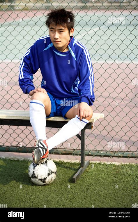 Young Soccer Player Sitting On Bench Stock Photo - Alamy