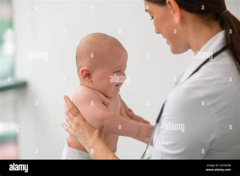 experienced pediatrician examining  newborn baby stock photo alamy