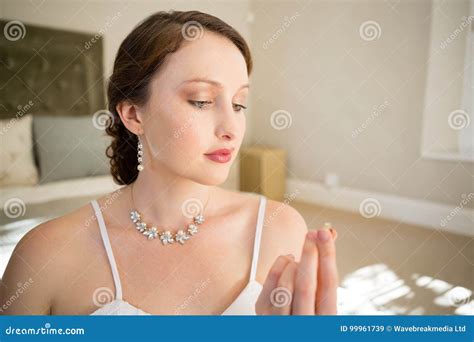 beautiful bride  wedding ring  sitting  bed stock image