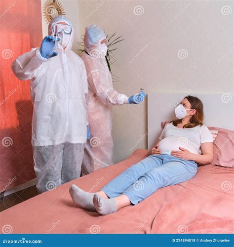Treatment of a Pregnant Woman at Home by Emergency Doctors Stock Photo