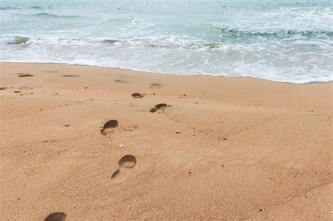 Premium Photo | Footprints in the sand on the beach