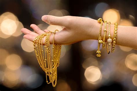 Premium Photo | Woman hand hold gold bracelet and necklace jewelry