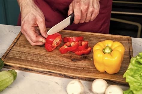 premium photo closeup  hands cutting vegetables  knife