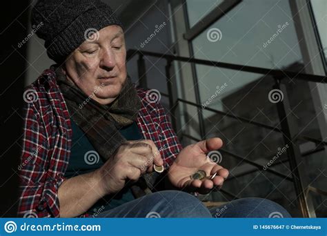 Poor Senior Man Counting Coins on Stairs Indoors Stock Image - Image of ...