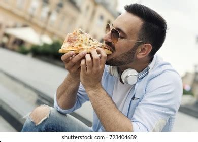 Handsome Young Man Eating Pizza Slice Stock Photo 723404689 | Shutterstock