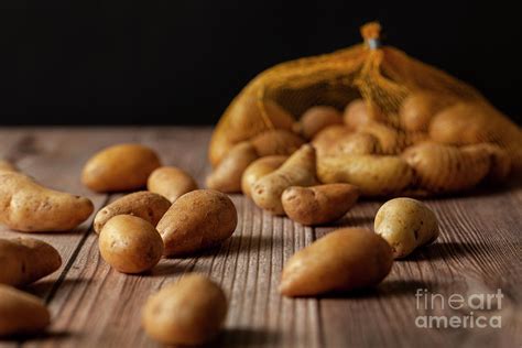 Moody Image Of Ratte Potatoes On Wood Photograph by Munir Akkaya - Pixels