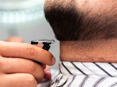 Free Photo | Close-up man getting his beard trimmed