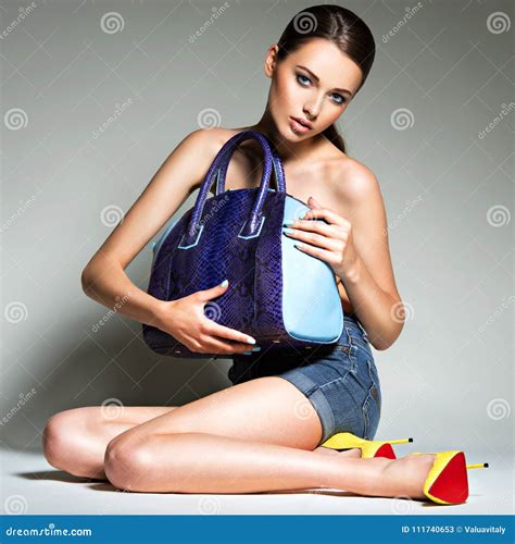 Beautiful Woman in High Heels Holds Handbag. Stock Image - Image of